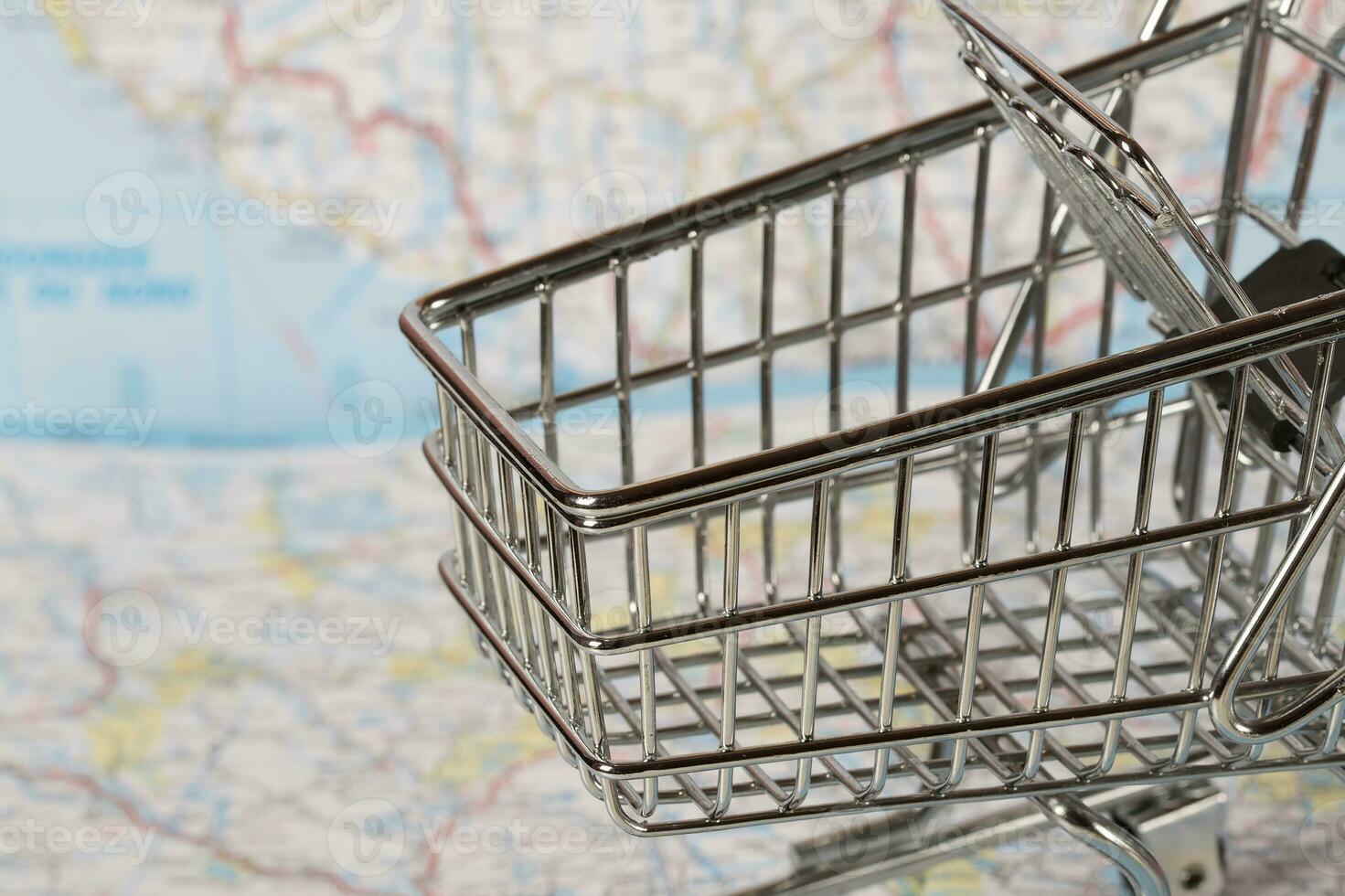 Mini shopping cart on a map. photo