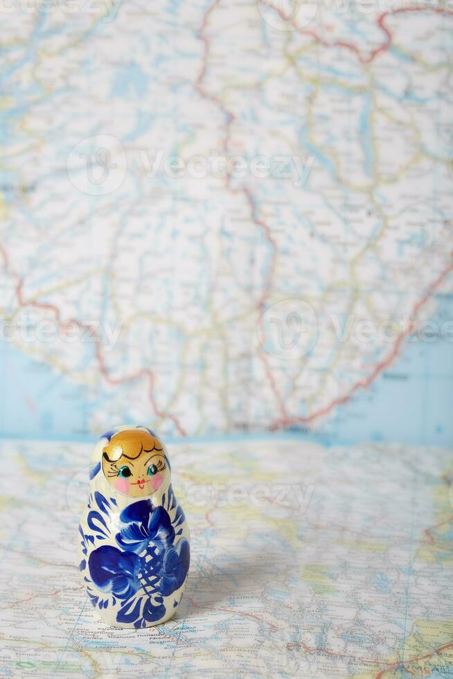 Russian matryoshka in gzhel style on a map. photo