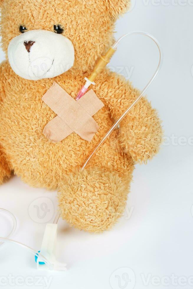 Teddy bear with blood transfusion system. Closeup photo