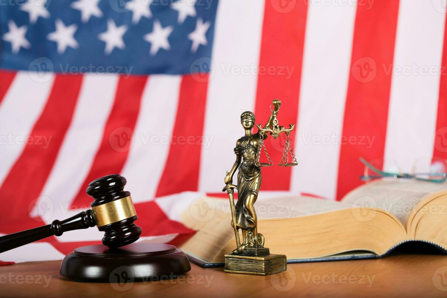 Statue of Themis and judge's gavel on a table. photo