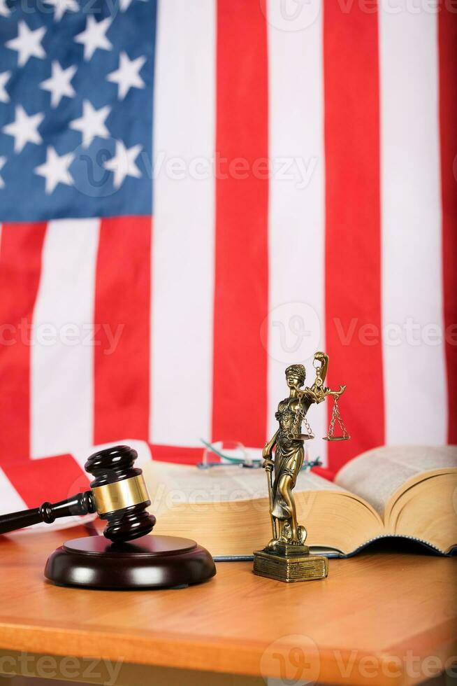 Statue of Themis and judge's gavel on a table. photo