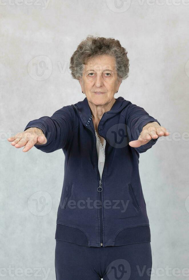 Senior woman is dressed in a sport costume photo