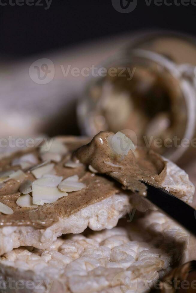 Homemade almond butter on a slice of rice crispbread. photo