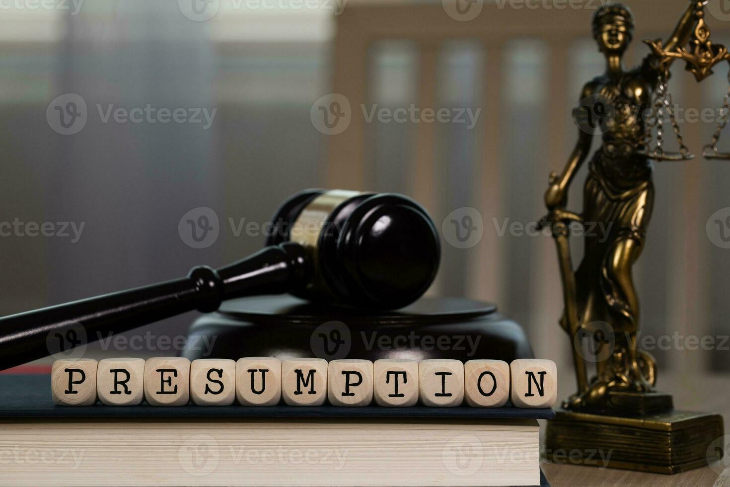 Word PRESUMPTION composed of wooden dices. Wooden gavel and statue of Themis in the background. photo