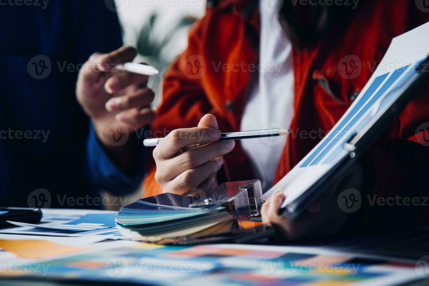 Close up ux developer and ui designer brainstorming about mobile app interface wireframe design on table with customer breif and color code at modern office.Creative digital development agency photo