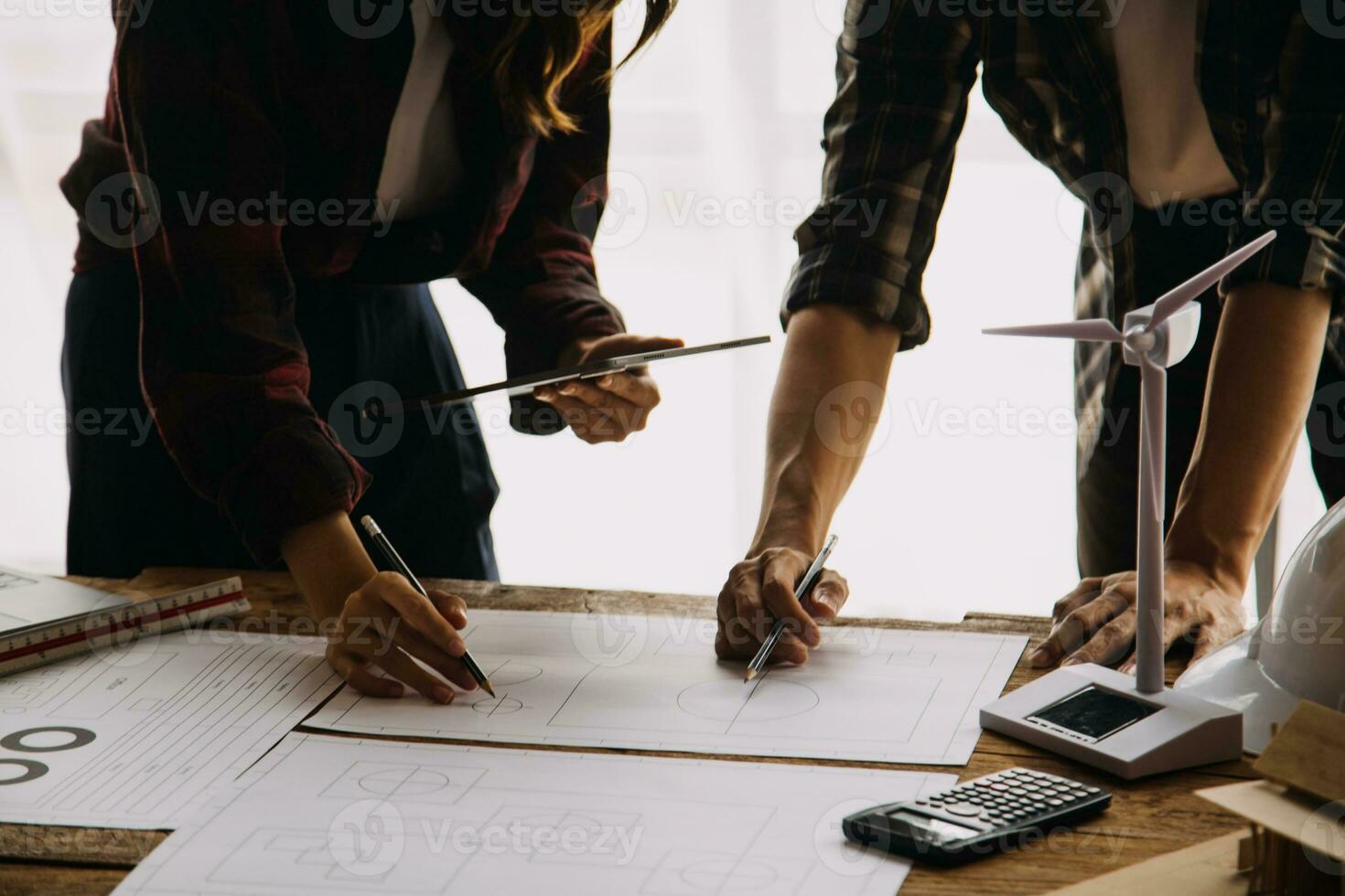 Professional Mechanical Engineer team Working on Personal Computer at Metal lathe industrial manufacturing factory. Engineer Operating lathe Machinery. Product quality Inspection photo