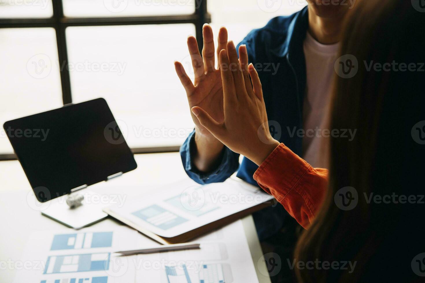 Close up ux developer and ui designer brainstorming about mobile app interface wireframe design on table with customer breif and color code at modern office.Creative digital development agency photo