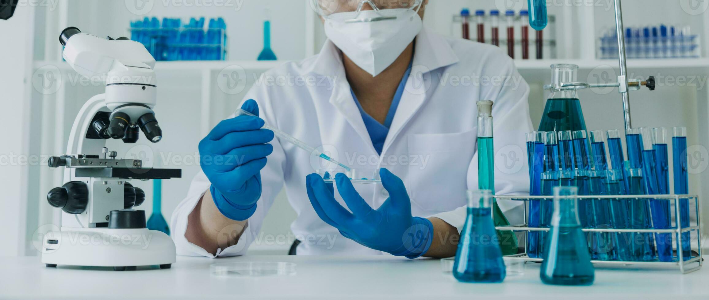 Medical Development Laboratory Caucasian Female Scientist Looking Under Microscope, Analyzes Petri Dish Sample. Specialists Working on Medicine, Biotechnology Research in Advanced Pharma Lab photo