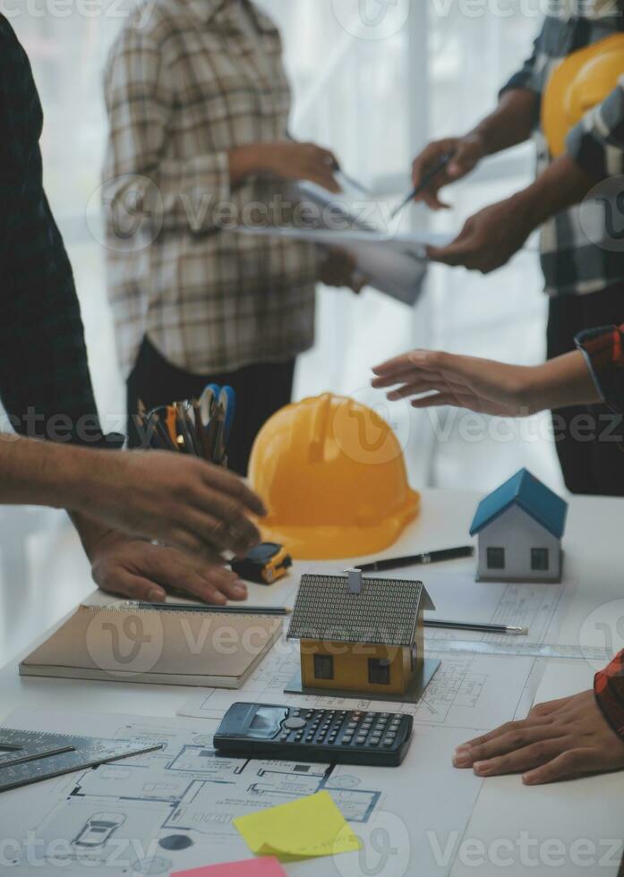 Engineer Teamwork Meeting, Drawing working on blueprint meeting for project working with partner on model building and engineering tools in working site, Construction and structure concept. photo