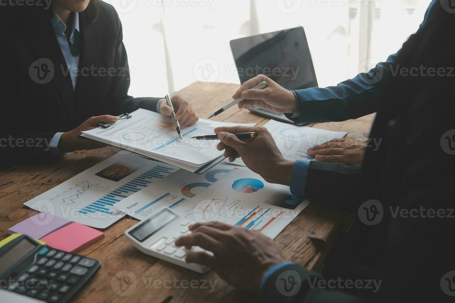 Financial analysts analyze business financial reports on a digital tablet planning investment project during a discussion at a meeting of corporate showing the results of their successful teamwork. photo