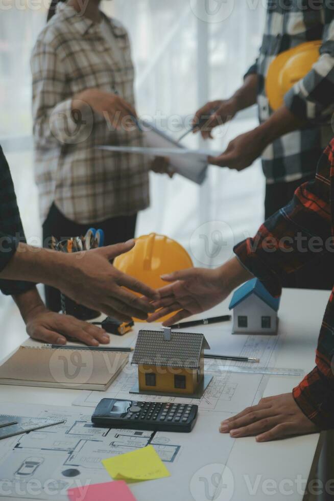 Engineer Teamwork Meeting, Drawing working on blueprint meeting for project working with partner on model building and engineering tools in working site, Construction and structure concept. photo