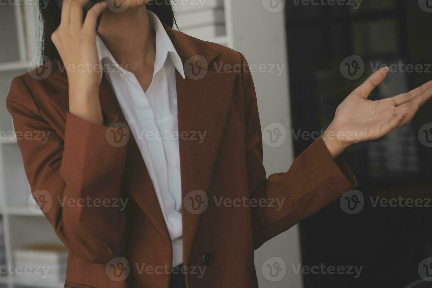 Asian Business woman using calculator and laptop for doing math finance on an office desk, tax, report, accounting, statistics, and analytical research concept photo