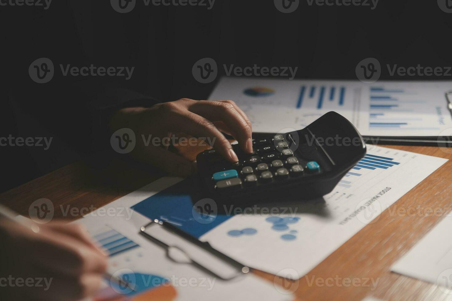 Close up businessman hand using calculator and working with laptop calculate about finance accounting at coffeeshop outdor.finance accounting concept photo