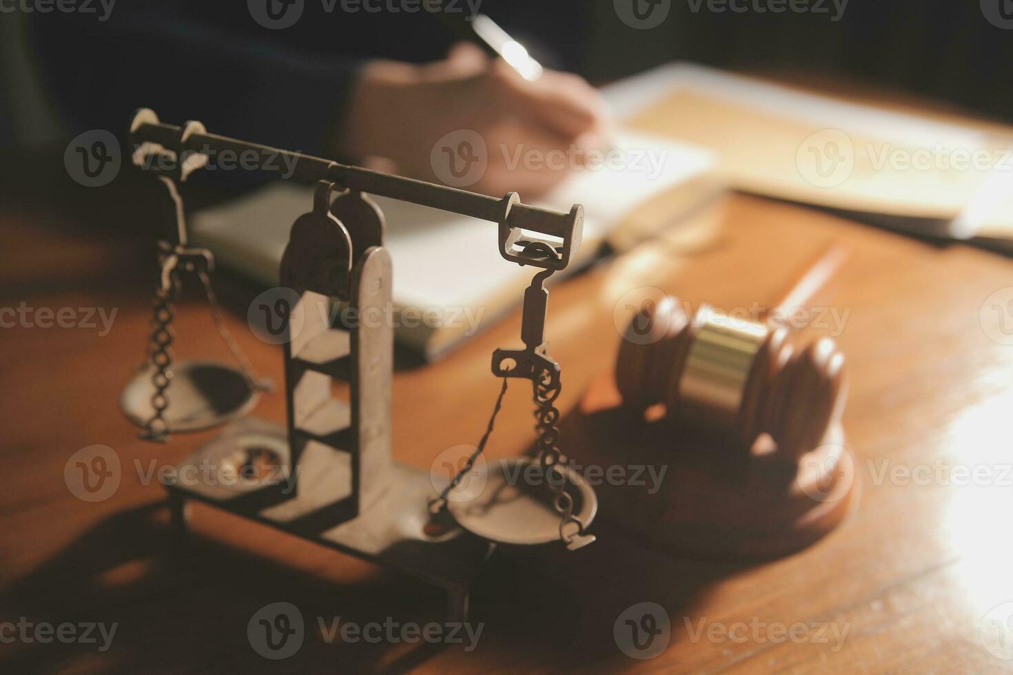 law books and scales of justice on desk in library of law firm. jurisprudence legal education concept. photo