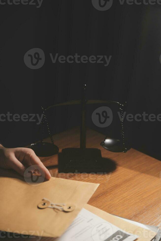 law books and scales of justice on desk in library of law firm. jurisprudence legal education concept. photo