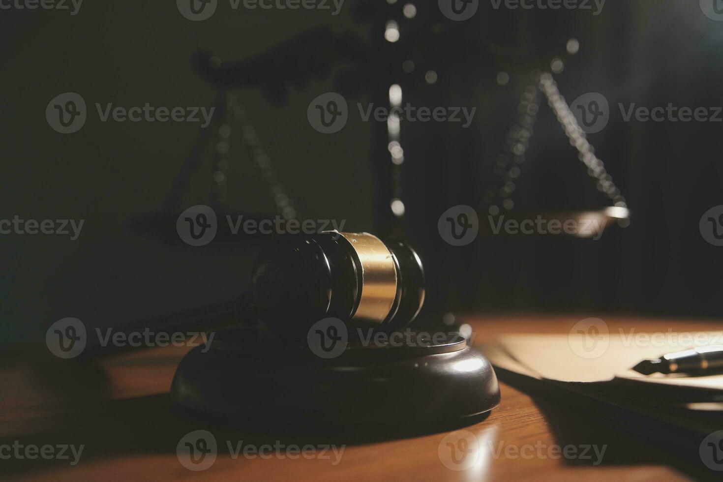 law books and scales of justice on desk in library of law firm. jurisprudence legal education concept. photo