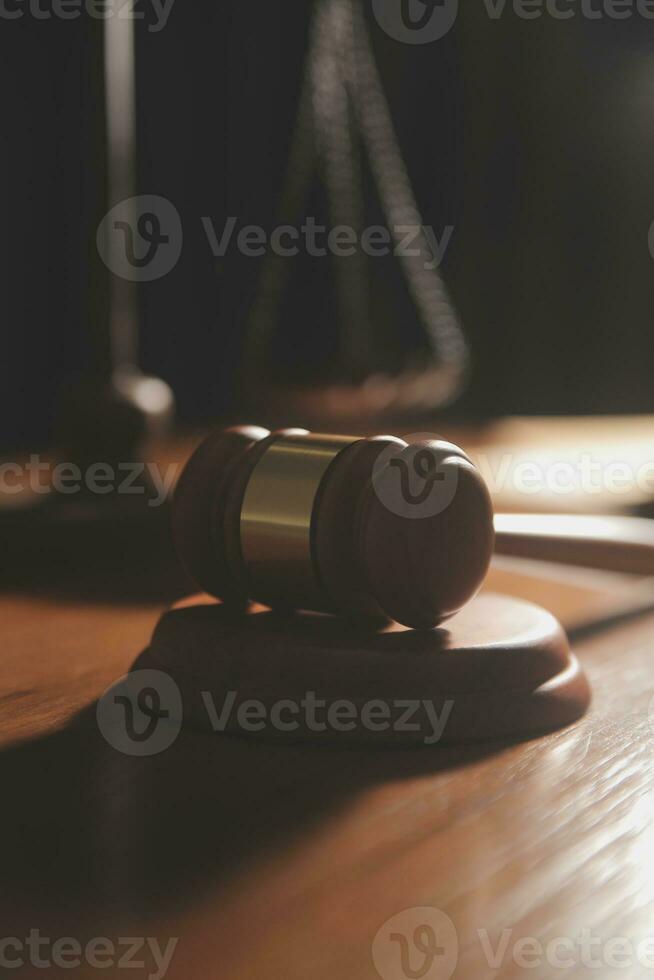 law books and scales of justice on desk in library of law firm. jurisprudence legal education concept. photo