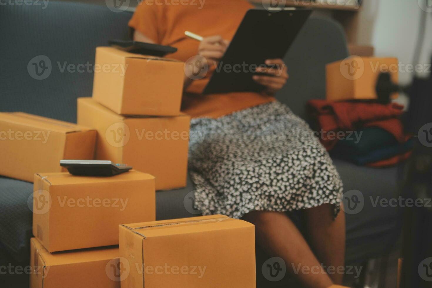 Business woman start up small business entrepreneur SME success .freelance woman working at home with Online Parcel delivery. SME and packaging deliveryconcept photo