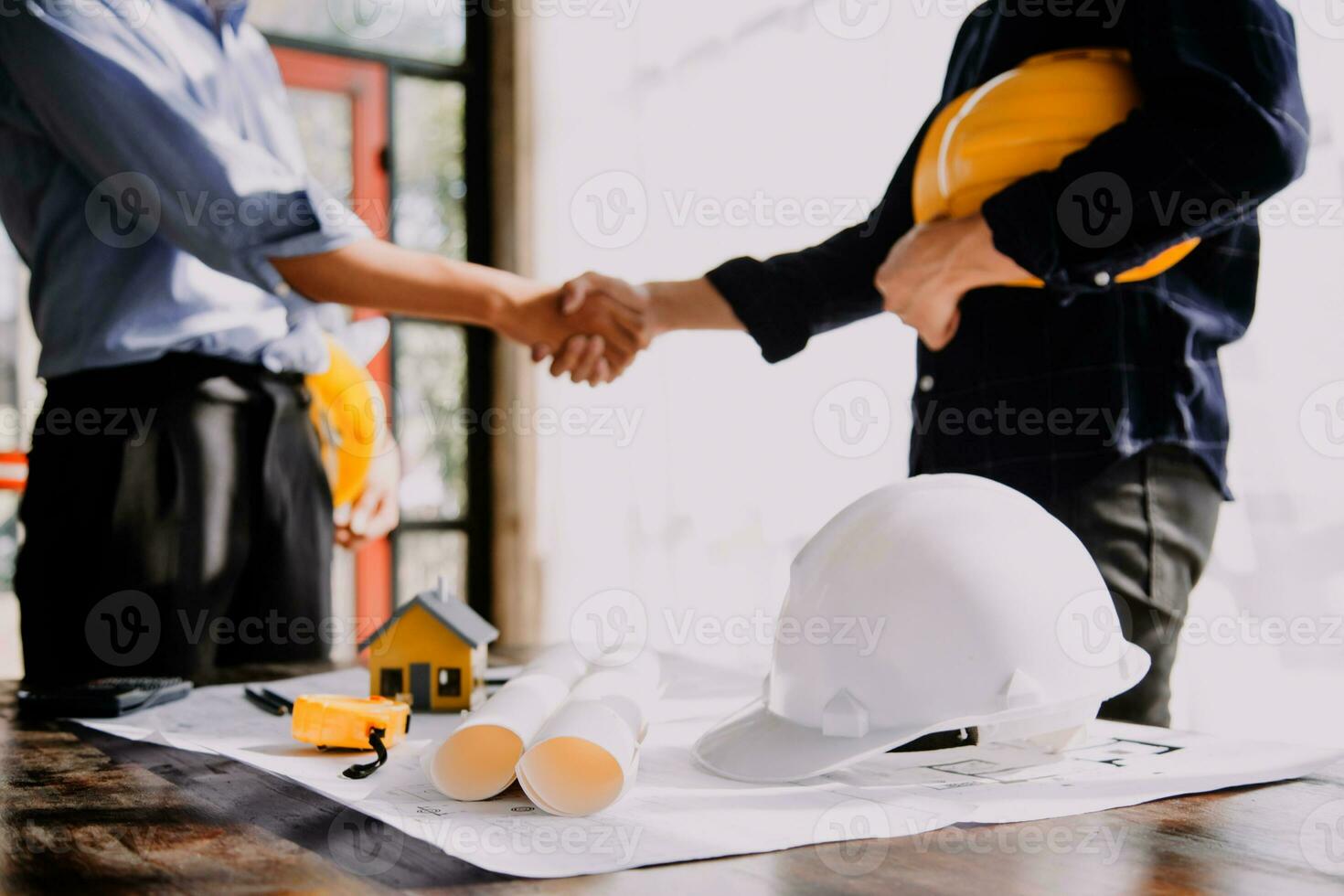Two Specialists Inspect Commercial, Industrial Building Construction Site. Real Estate Project with Civil Engineer, Investor Use Laptop. In the Background Crane, Skyscraper Concrete Formwork Frames photo