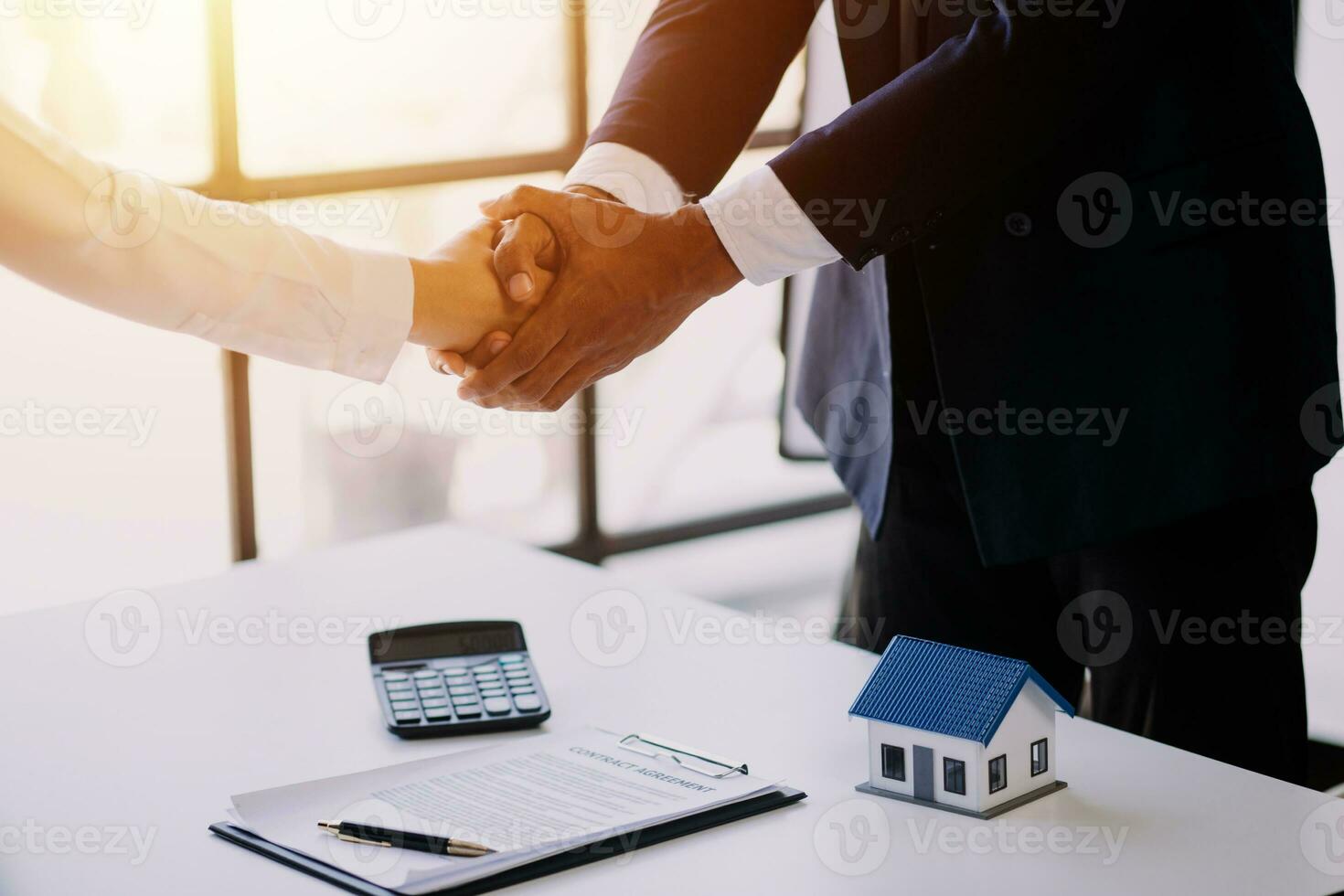 Accountant, businessman, real estate agent, Asian business woman handing keys to customers along with house after customers to sign photo