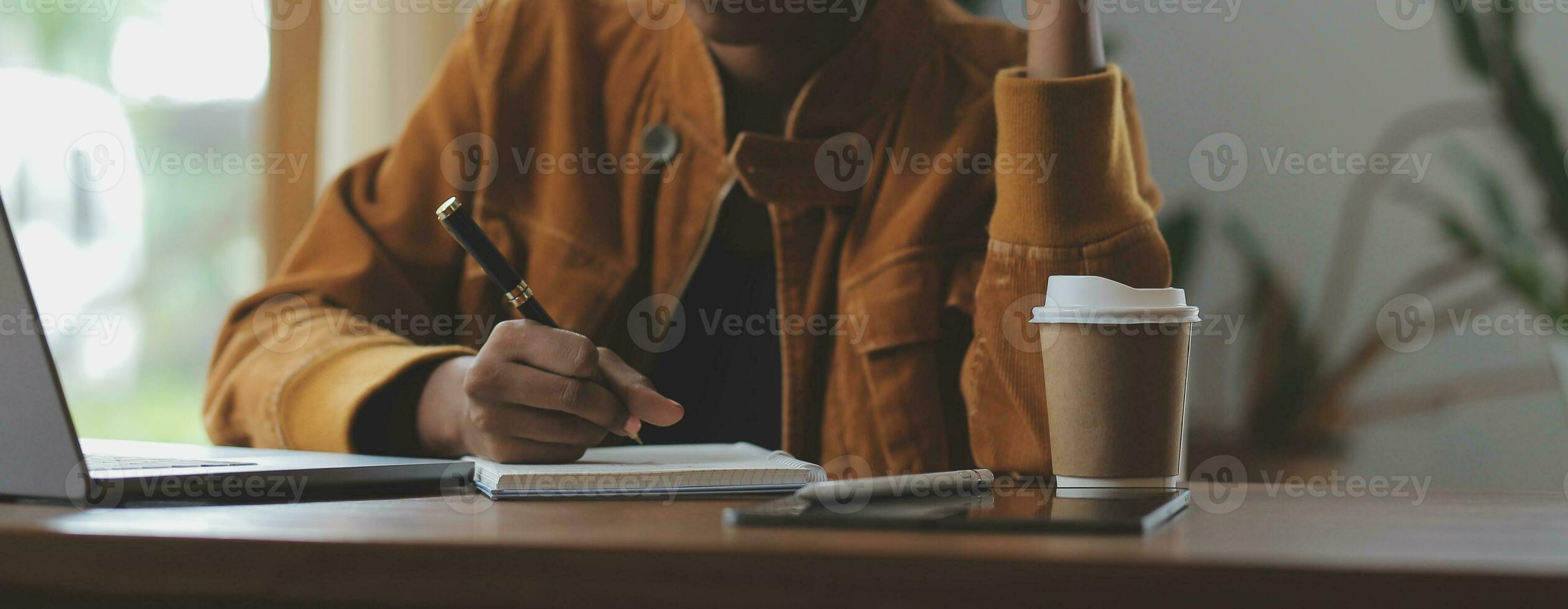 Portrait of Young Asian woman hand freelancer is working her job on computer tablet in modern office. Doing accounting analysis report real estate investment data, Financial and tax systems concept. photo