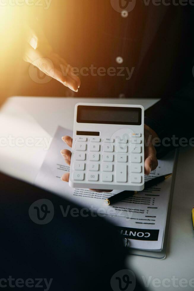 A car rental company employee is handing out the car keys to the renter after discussing the rental details and conditions together with the renter signing a car rental agreement. Concept car rental. photo