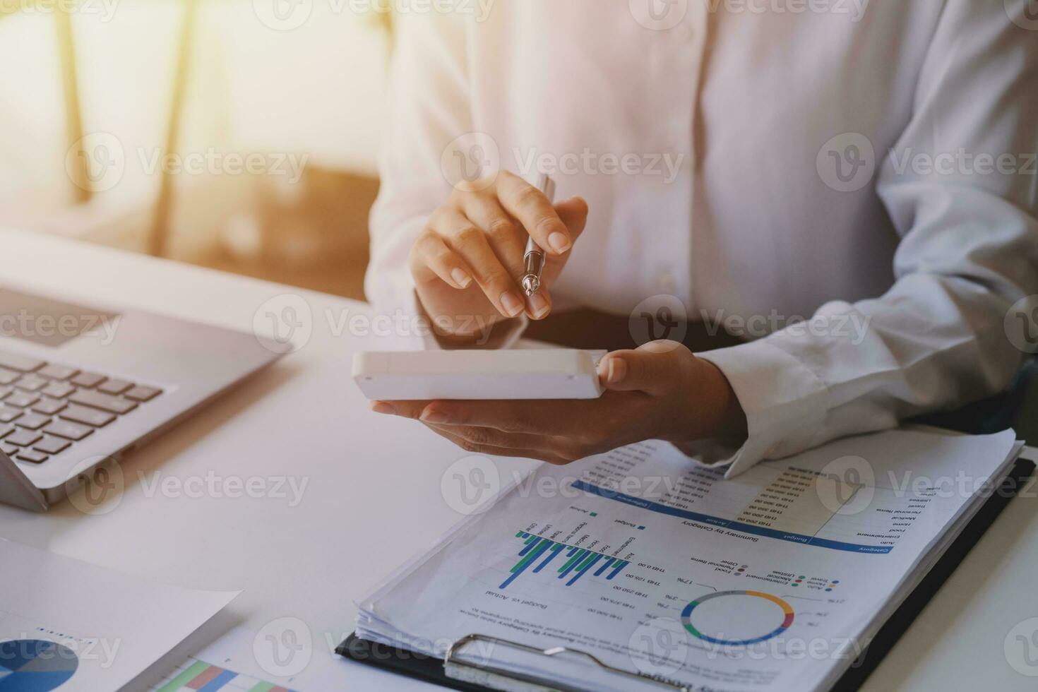 businessman working on desk office with using a calculator to calculate the numbers, finance accounting concept photo