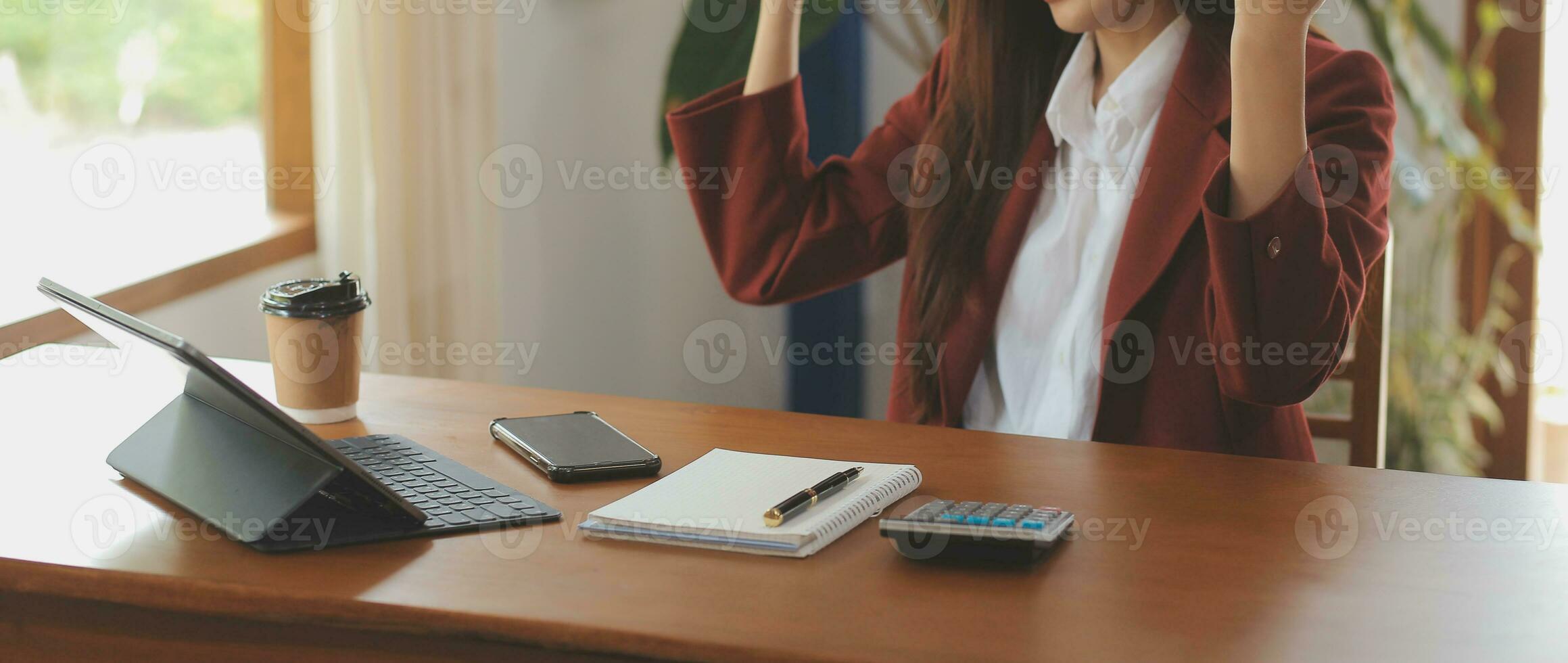Asian Business woman using calculator and laptop for doing math finance on an office desk, tax, report, accounting, statistics, and analytical research concept photo
