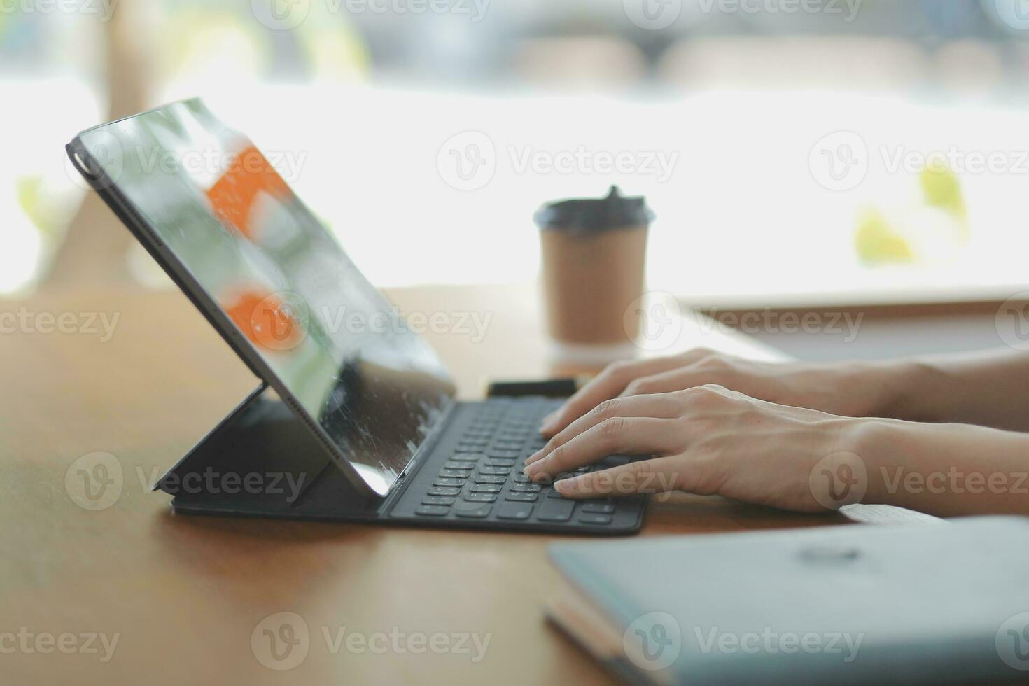 Asian Business woman using calculator and laptop for doing math finance on an office desk, tax, report, accounting, statistics, and analytical research concept photo