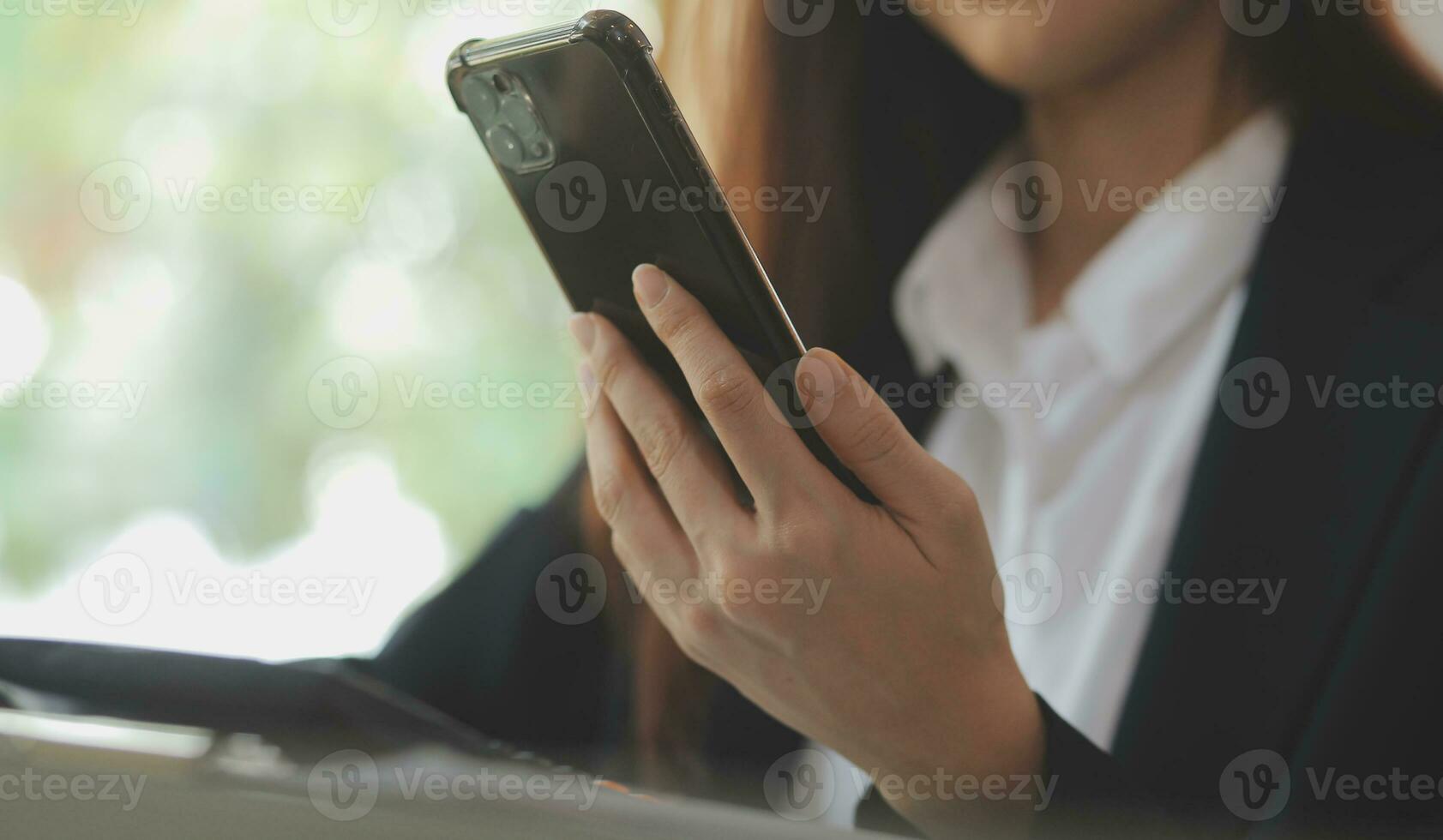 Asian Business woman using calculator and laptop for doing math finance on an office desk, tax, report, accounting, statistics, and analytical research concept photo