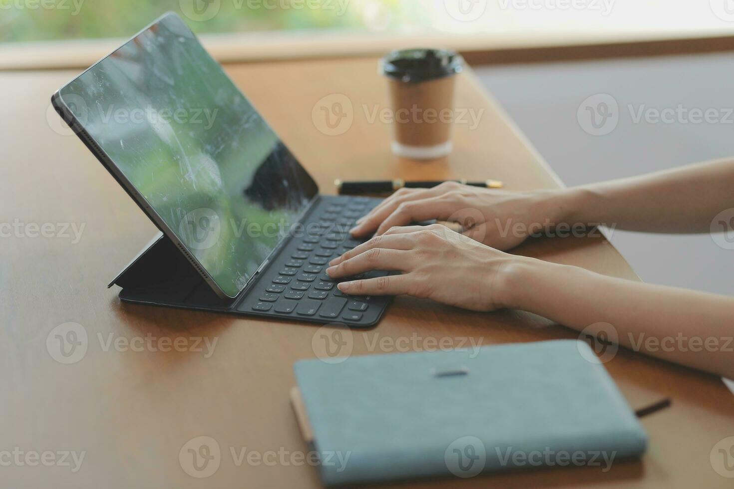 Asian Business woman using calculator and laptop for doing math finance on an office desk, tax, report, accounting, statistics, and analytical research concept photo