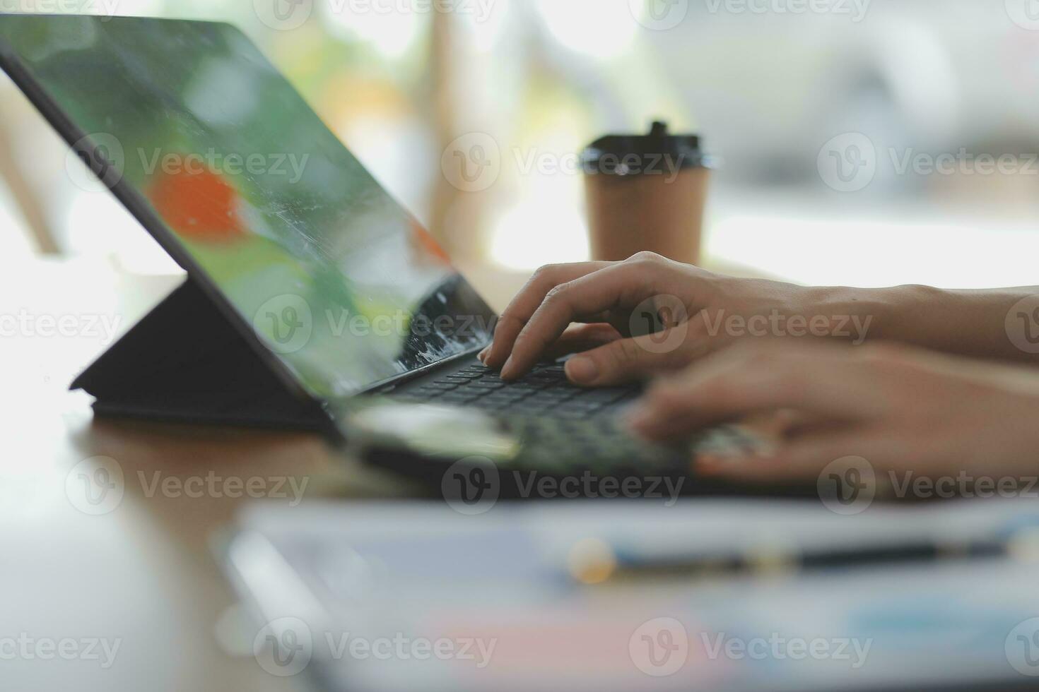 Asian Business woman using calculator and laptop for doing math finance on an office desk, tax, report, accounting, statistics, and analytical research concept photo