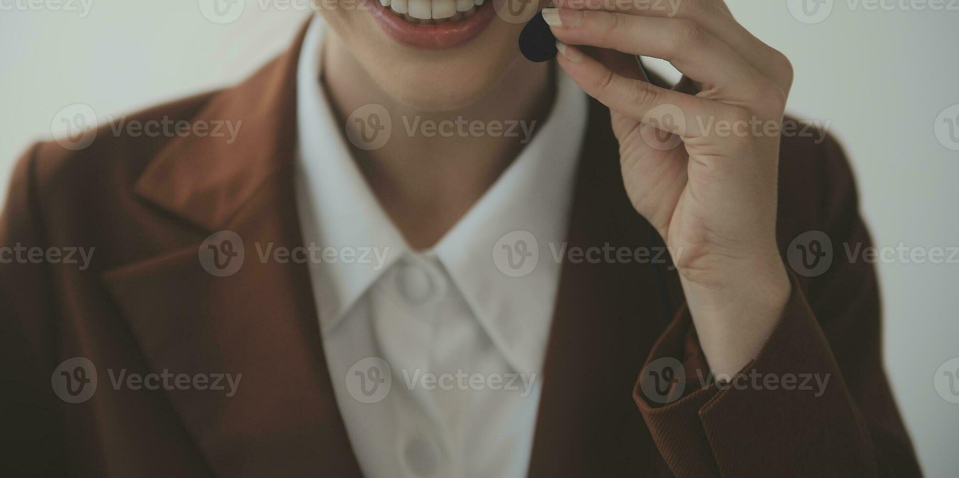 Customer service representative with curly hair talking through headset photo