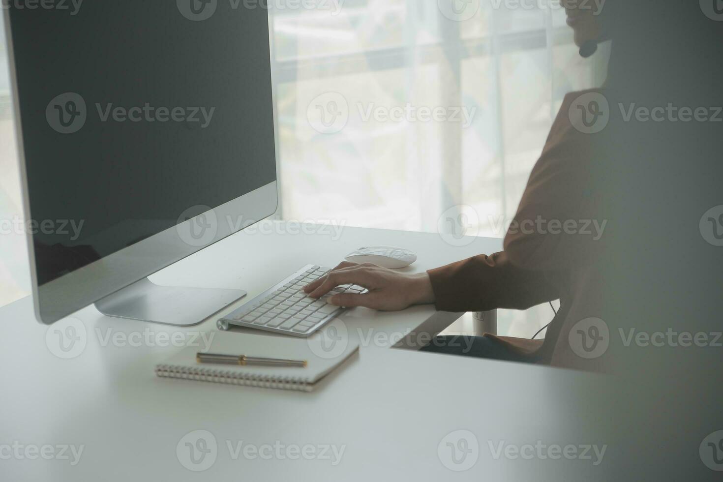 Customer service representative with curly hair talking through headset photo