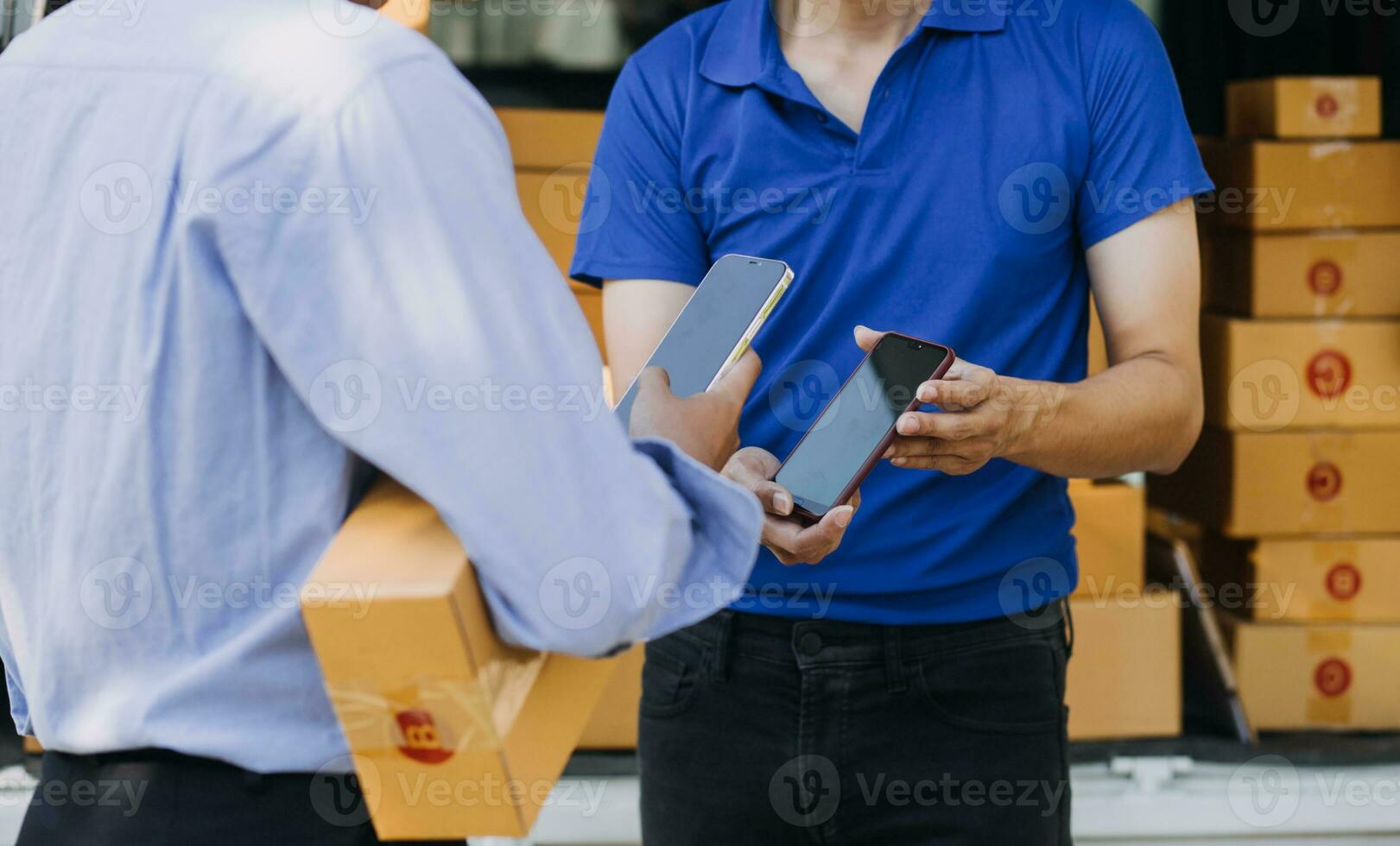 Blue Delivery Men Unloading Package From Truck With Face Mask photo
