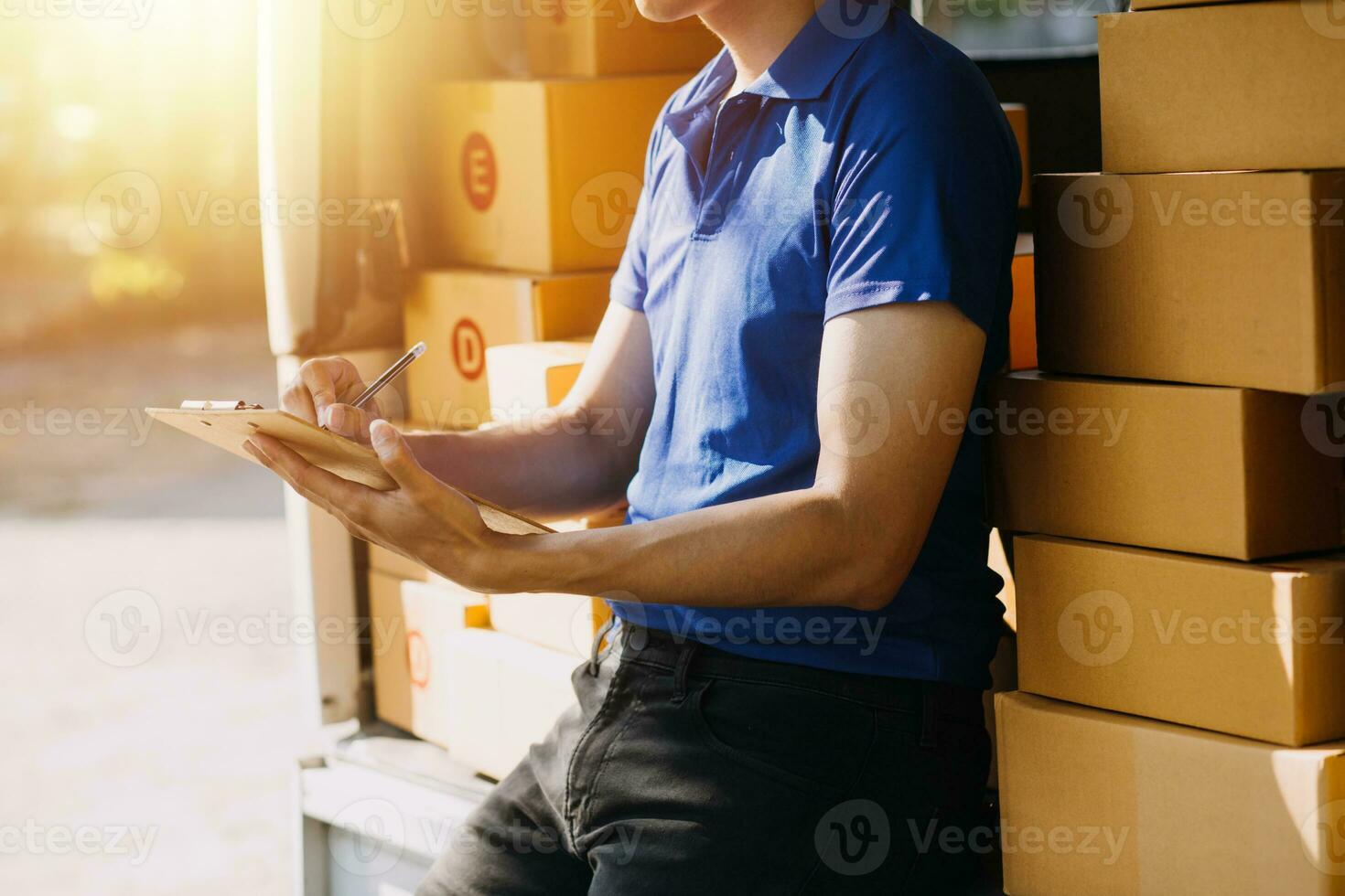 Blue Delivery Men Unloading Package From Truck With Face Mask photo