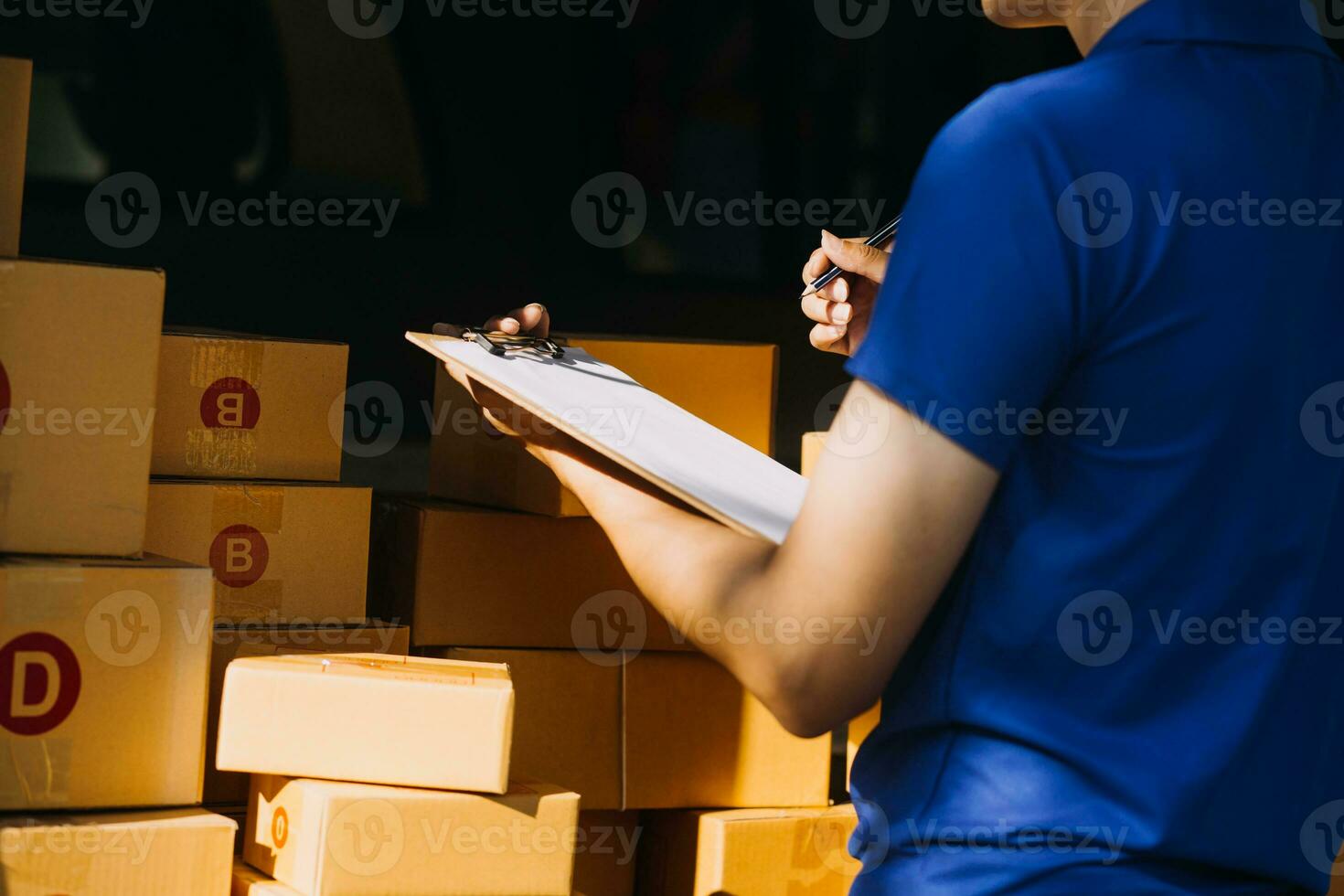 Blue Delivery Men Unloading Package From Truck With Face Mask photo