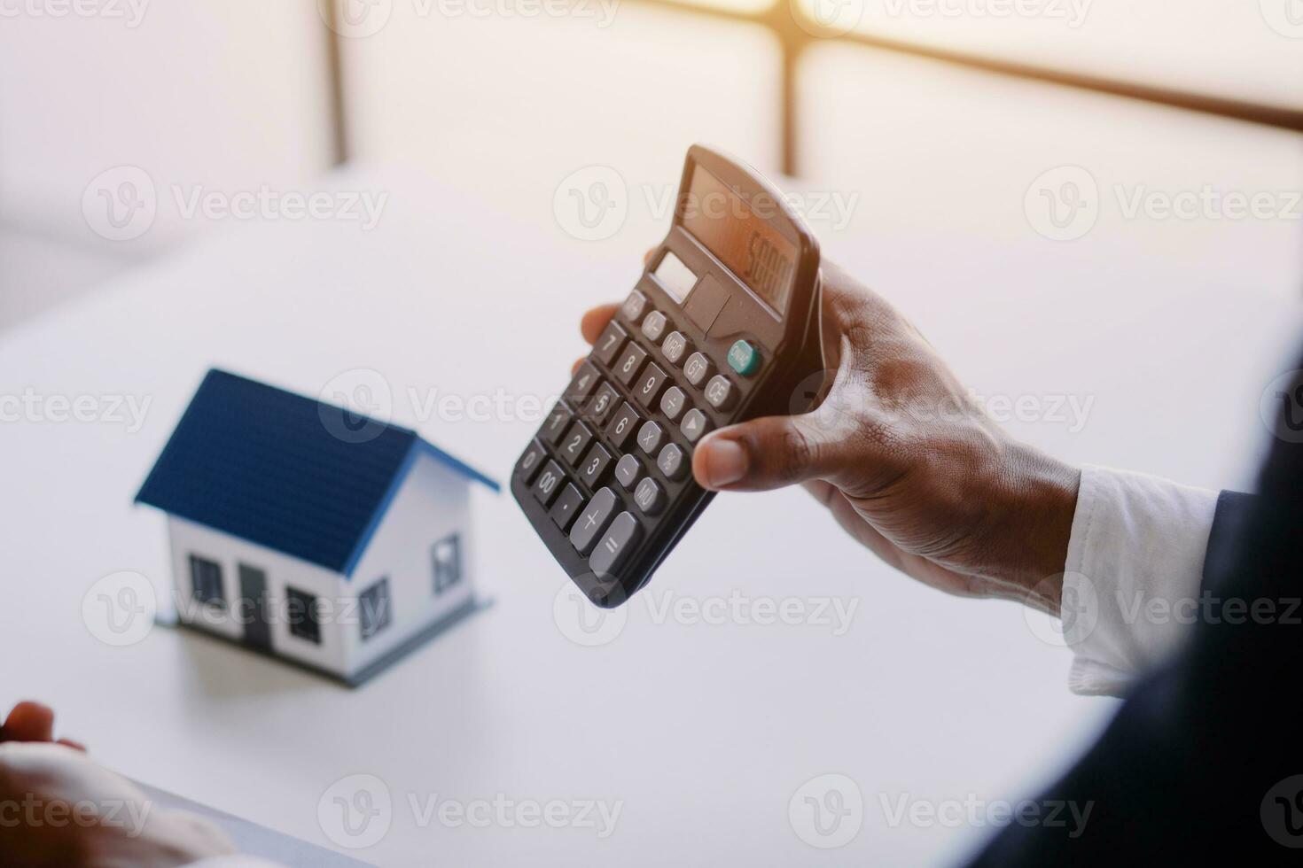 Accountant, businessman, real estate agent, Asian business woman handing keys to customers along with house after customers to sign photo