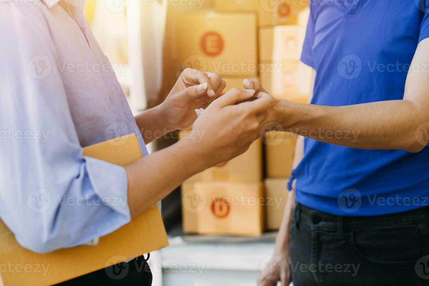 Blue Delivery Men Unloading Package From Truck With Face Mask photo