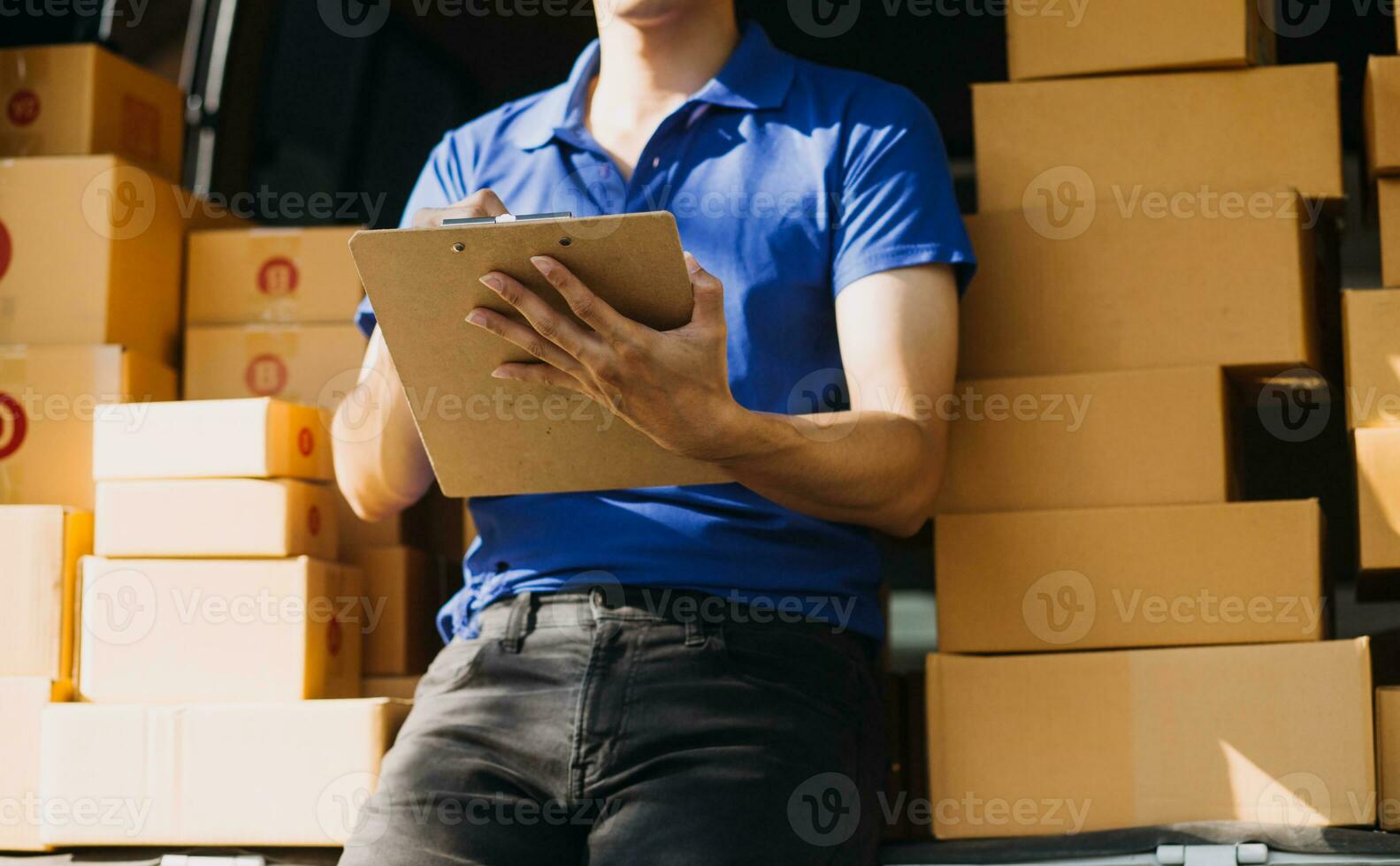 Blue Delivery Men Unloading Package From Truck With Face Mask photo