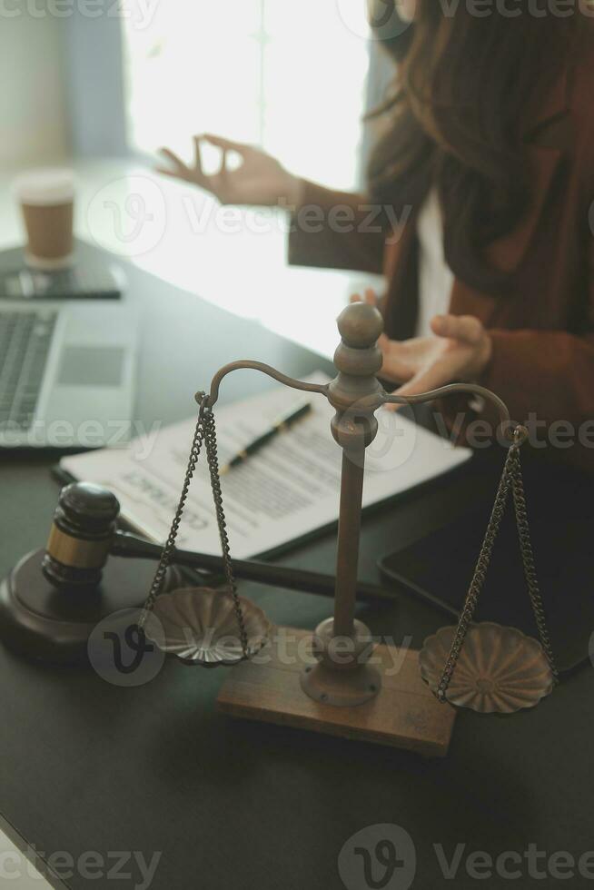 Business and lawyers discussing contract papers with brass scale on desk in office. Law, legal services, advice, justice and law concept picture with film grain effect photo
