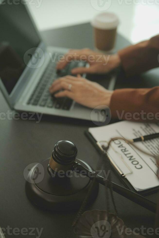 Business and lawyers discussing contract papers with brass scale on desk in office. Law, legal services, advice, justice and law concept picture with film grain effect photo