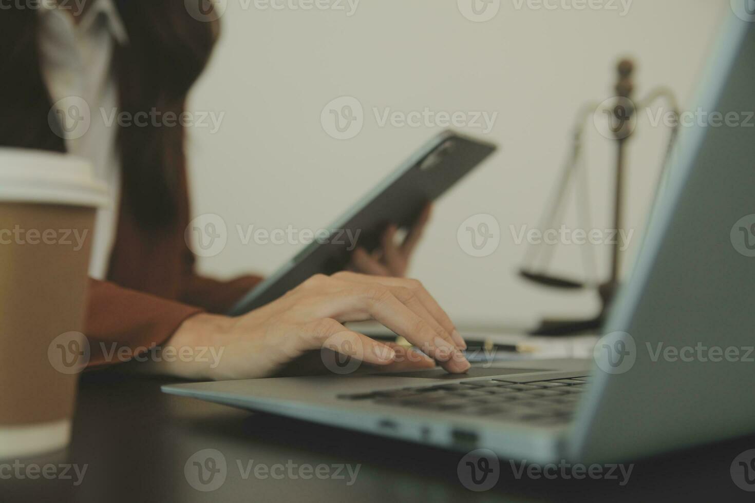 Business and lawyers discussing contract papers with brass scale on desk in office. Law, legal services, advice, justice and law concept picture with film grain effect photo