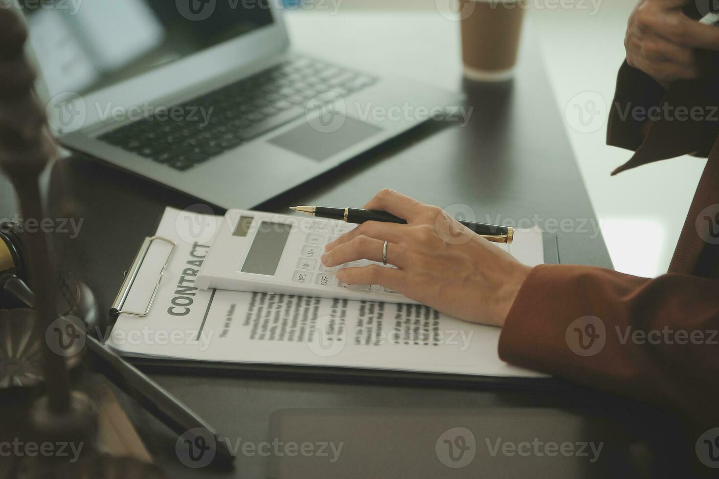 Business and lawyers discussing contract papers with brass scale on desk in office. Law, legal services, advice, justice and law concept picture with film grain effect photo