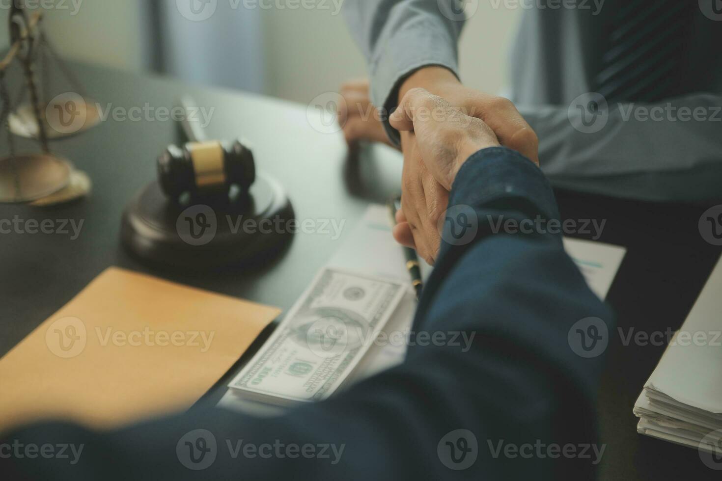 Business and lawyers discussing contract papers with brass scale on desk in office. Law, legal services, advice, justice and law concept picture with film grain effect photo