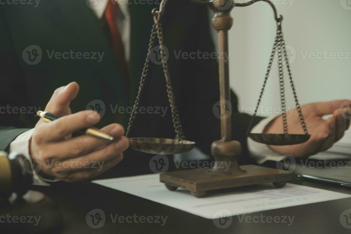 Business and lawyers discussing contract papers with brass scale on desk in office. Law, legal services, advice, justice and law concept picture with film grain effect photo