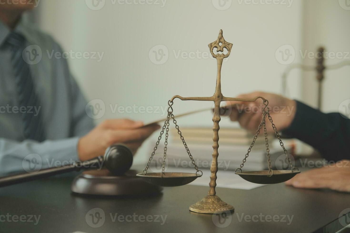 Business and lawyers discussing contract papers with brass scale on desk in office. Law, legal services, advice, justice and law concept picture with film grain effect photo