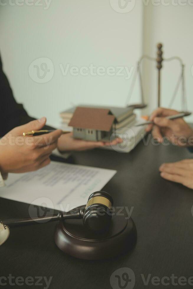 Business and lawyers discussing contract papers with brass scale on desk in office. Law, legal services, advice, justice and law concept picture with film grain effect photo