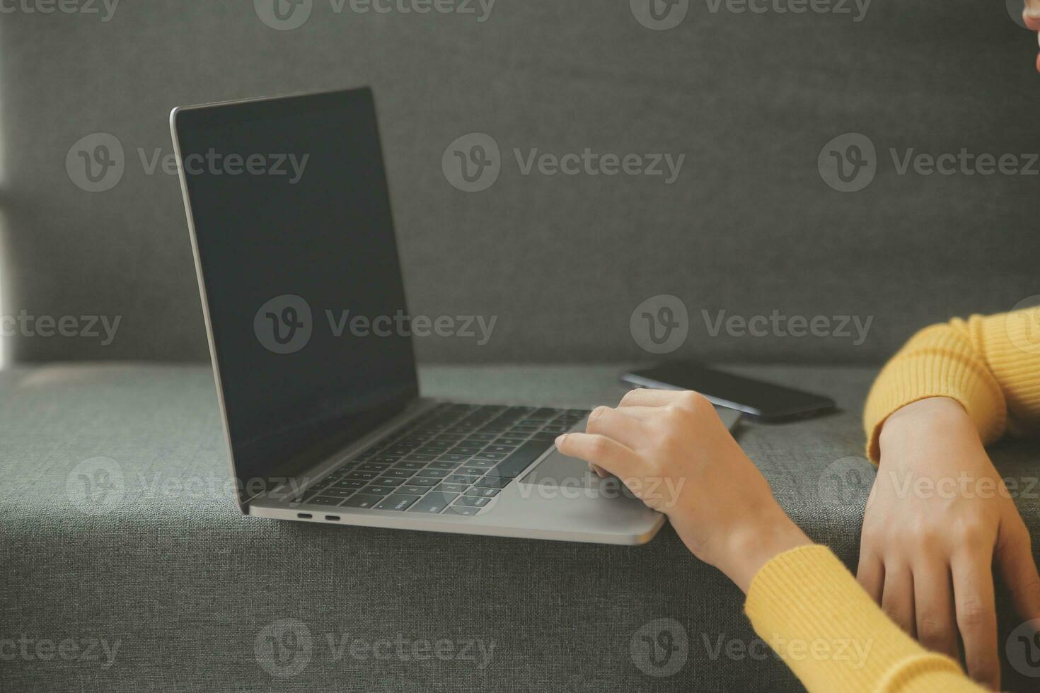Young adult happy smiling Hispanic Asian student wearing headphones talking on online chat meeting using laptop in university campus or at virtual office. College female student learning remotely. photo