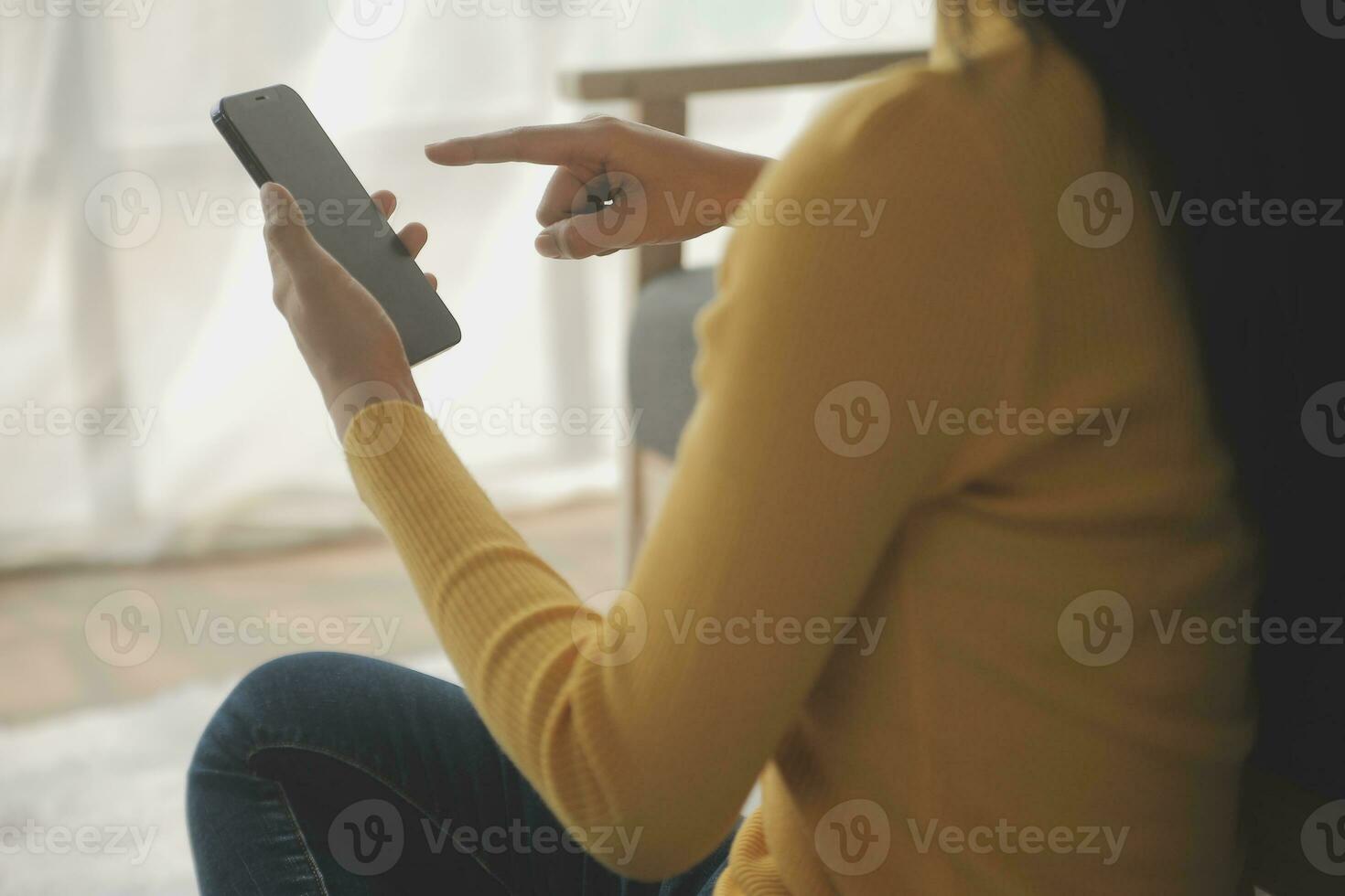 Young adult happy smiling Hispanic Asian student wearing headphones talking on online chat meeting using laptop in university campus or at virtual office. College female student learning remotely. photo